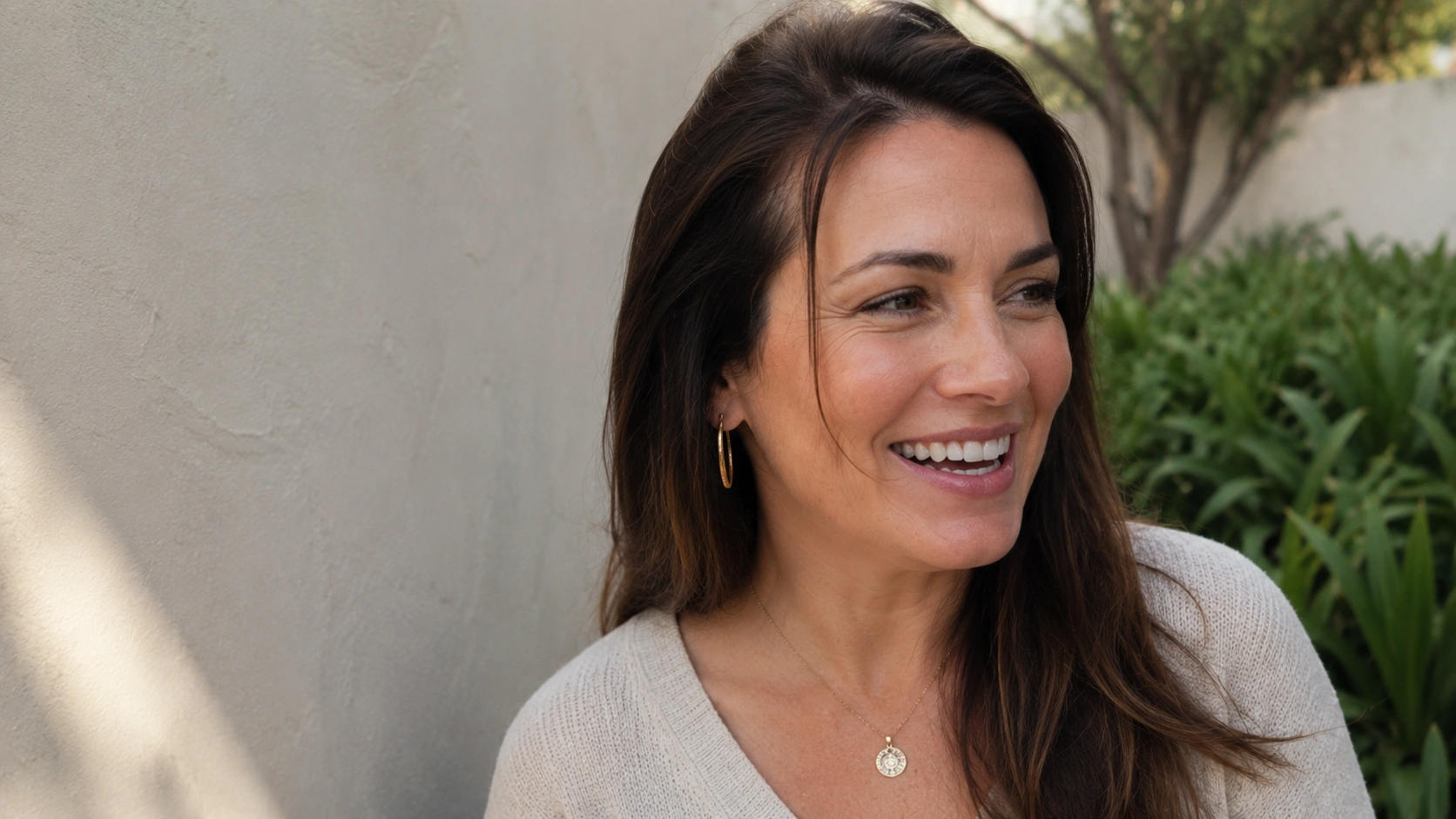 Woman with smooth, even-toned skin outdoors after microneedling treatment