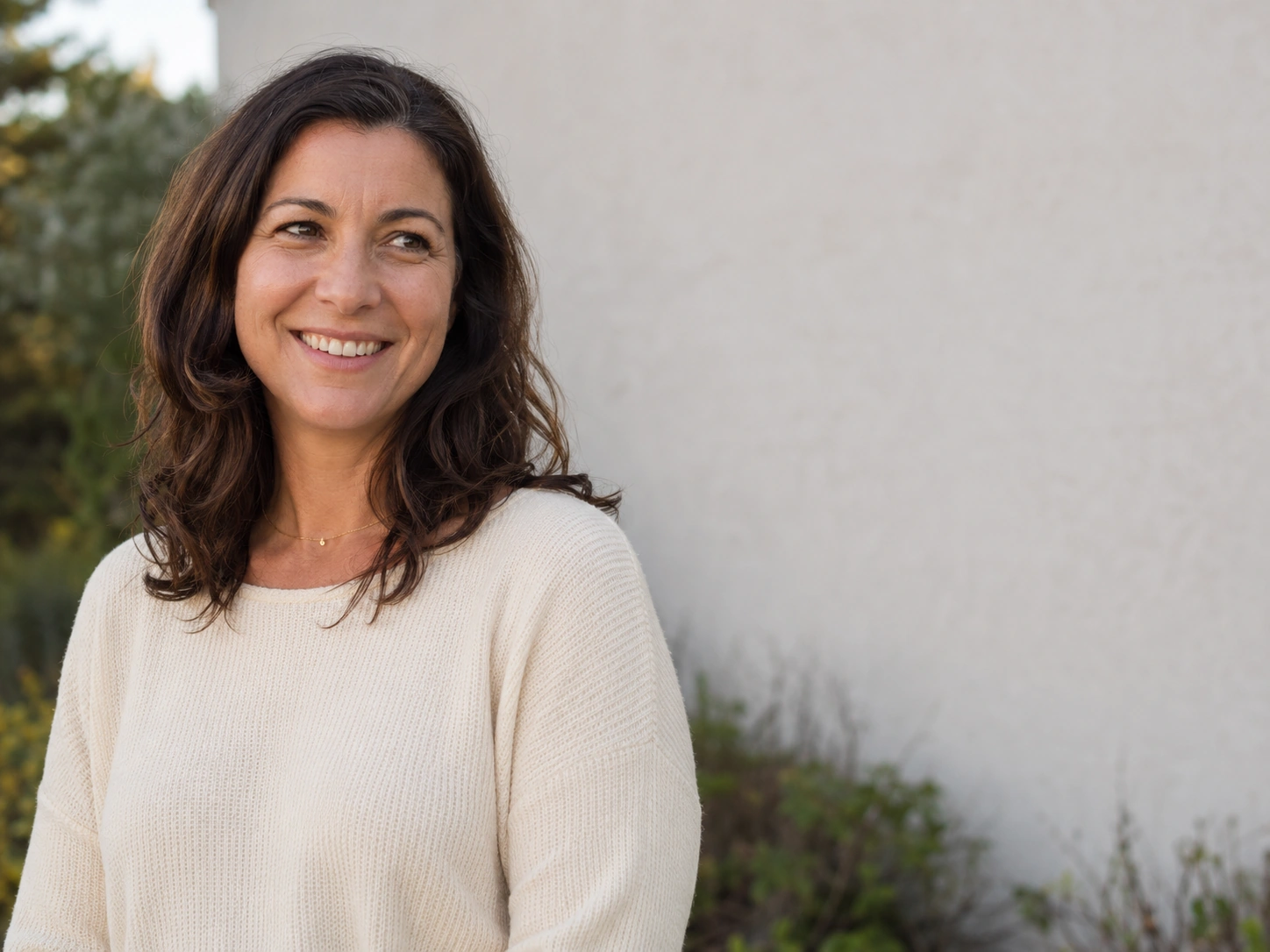 Woman with smooth, natural-looking forehead and expressive smile after Botox treatment